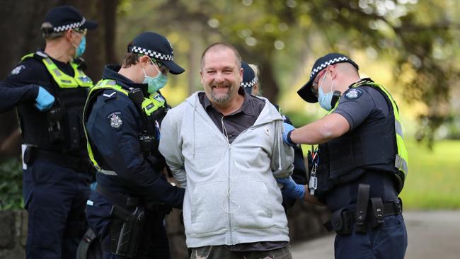 Police arrest a man at an anti-lockdown protest in Melbourne on Saturday. Picture: Alex Coppel.