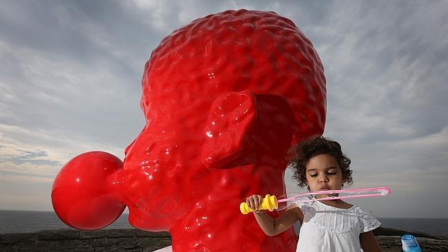 Josie Diaz (3) blowing bubbles at Bubble No:5 by artist Qian Sihua.