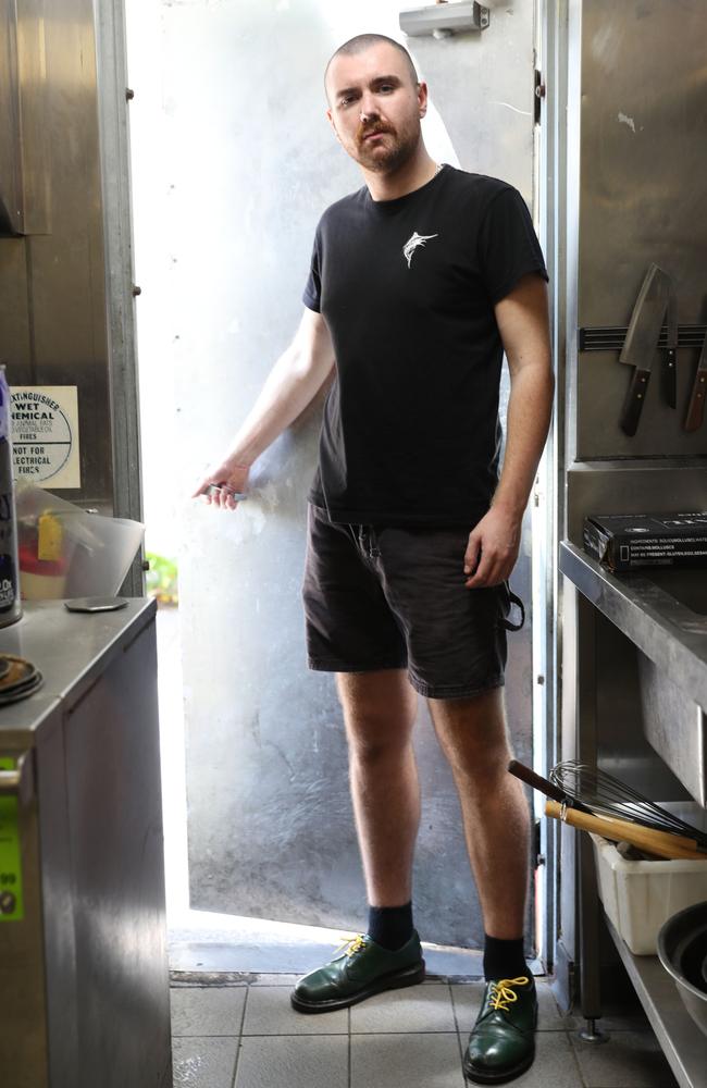 Deck Bar worker Aaron Trainor showing how thieves gained entry to the Darwin pub after it was broken into seven times over the three-day Christmas break.