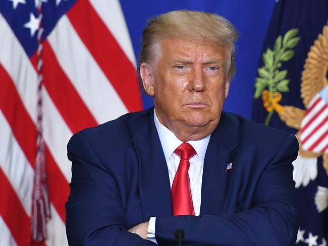 US President Donald Trump listens to officials during a roundtable discussion on community safety, at Mary D. Bradford High School in in Kenosha, Wisconsin on September 1, 2020. - Trump said Tuesday on a visit to protest-hit Kenosha, Wisconsin that recent anti-police demonstrations in the city were acts of "domestic terror" committed by violent mobs. "These are not acts of peaceful protest but really domestic terror," Trump said, describing multiple nights of angry demonstrations last week after a white police officer in Kenosha shot a black man in the back at close range. (Photo by MANDEL NGAN / AFP)