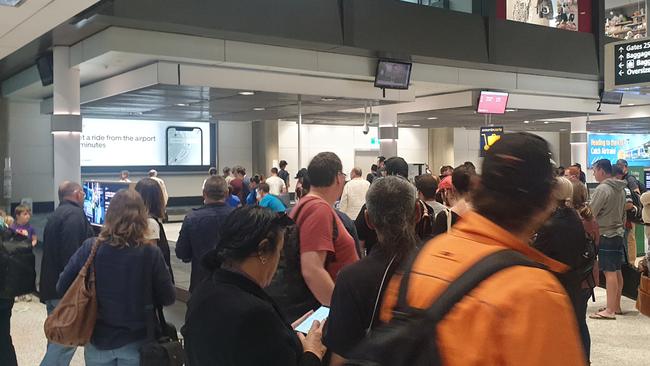 Social distancing was near impossible at Brisbane Airport after the border reopened. Photo: Tom Morgan