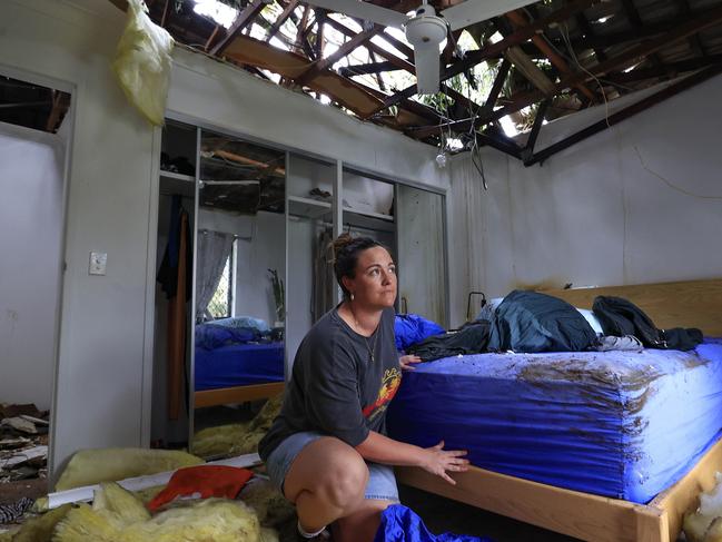 Gold Coasters are waking up to see what damage TC Alfred has caused as Lizzy Burke tries to clean up her Elanora home after a tree went through the roof. Pics Adam Head