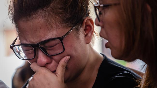 Ningsi Ayorbaba awaits news of her husband Paul Ferdinan Ayorbaba yesterday. Picture: Getty Images