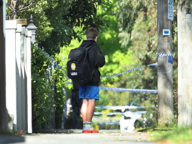 A child watches on outside the school. Picture: David Caird