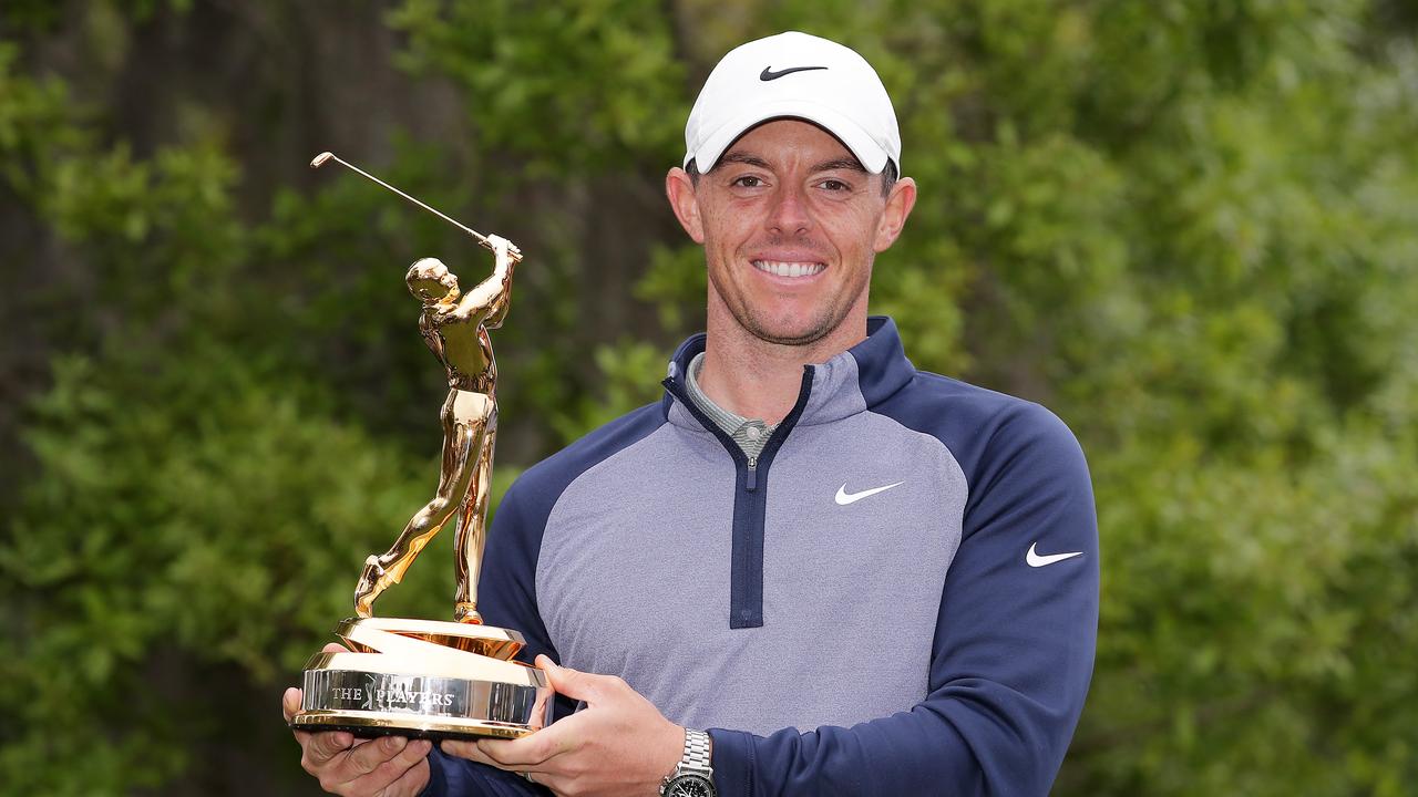 Rory McIlroy of Northern Ireland celebrates with the trophy after winning The PLAYERS Championship.