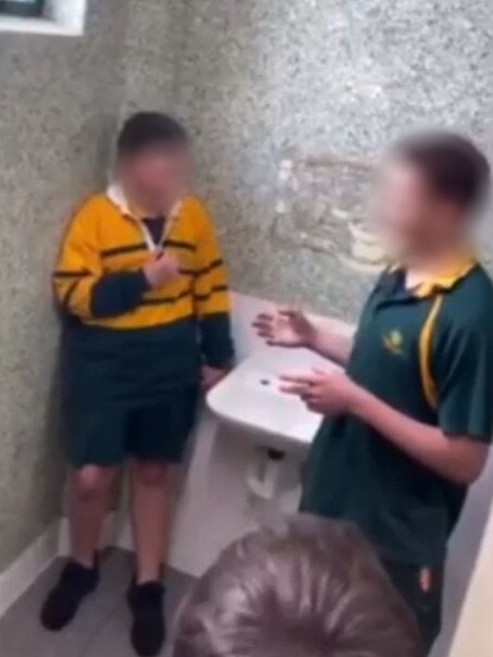 A Golden Grove High School Year 7 students cowers in a toilet cubicle corner before an older student assaults him. Picture: Supplied