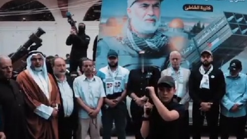 Fayez Elhasani (third from right) posed with Palestinian Islamic Jihad members holding weapons at a memorial for his brother Iyad in May 2023.