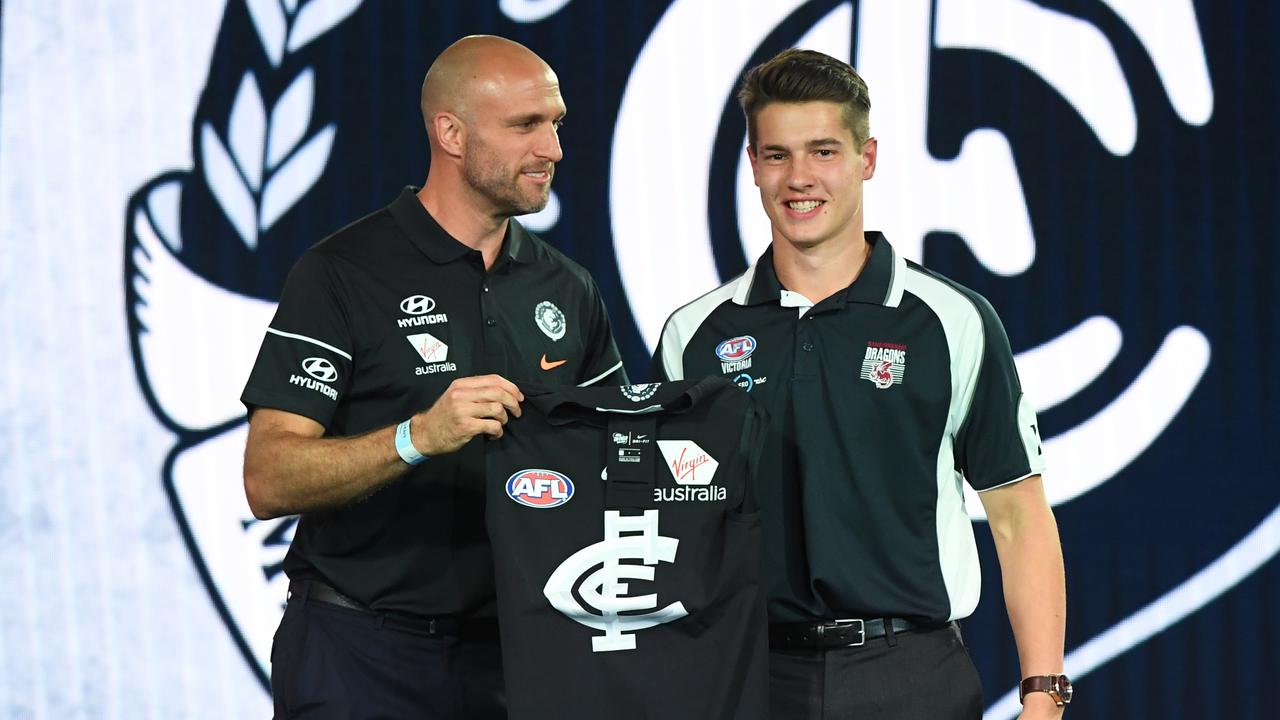 Number 19 pick Liam Stocker (right) is seen during the 2018 AFL Draft at Marvel Stadium in Melbourne, Thursday, November 22, 2018. (AAP Image/James Ross) NO ARCHIVING