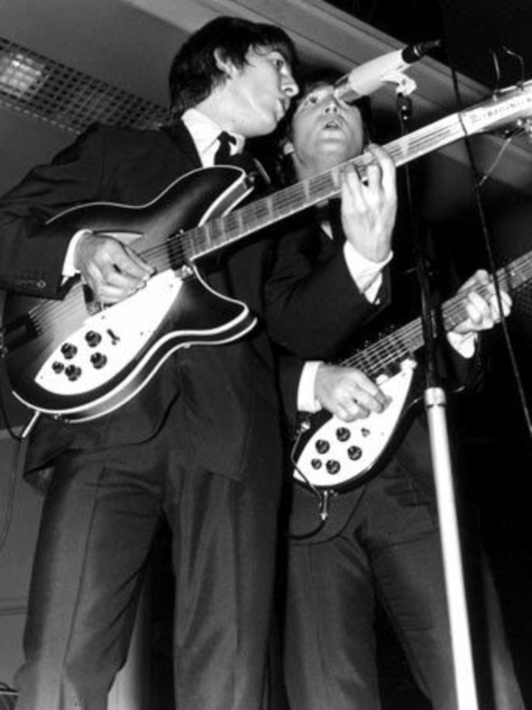 George Harrison and John Lennon on stage at Festival Hall.