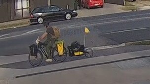 CCTV shows a person, believed to be Mr McLean, riding an electric bike with a trailer in Wangaratta. Picture: Victoria Police