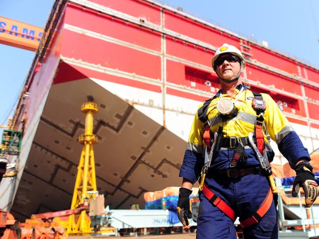 A worker in front of the stern of the Shell Prelude Floating LNG barge at Samsung Heavy Industries shipyard in Geoje, South Korea on October 15, 2013. Source: Supplied, Shell