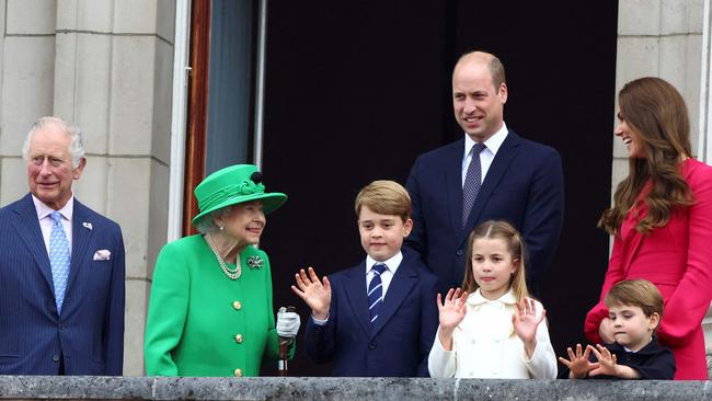 The Queen with princes Charles George William and Louie and Catherine, Duchess of Cambridge, and Princess Charlotte. Picture: AFP