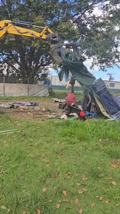 Excavators dismantle tents in city's homeless crackdown