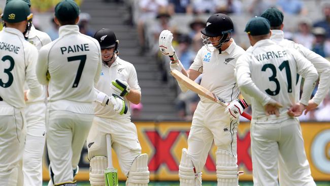 Santner inspects his glove as players wait for the result of the review. Picture: AFP