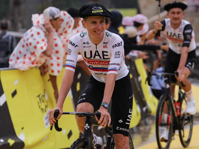 UAE Team Emirates' Slovenian rider Tadej Pogacar cycles with teammates to the stage during the official teams presentation near the Guggenheim Museum Bilbao, in Bilbao, northern Spain, on June 29, 2023, two days prior to the start of the 110th edition of the Tour de France cycling race. (Photo by Thomas SAMSON / AFP)