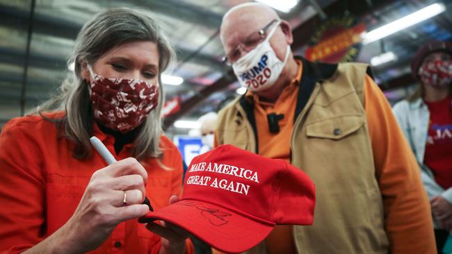 Senate candidate Senator Joni Ernst (R-IA), signs a MAGA hat for a Trump supporter at a campaign event in Davenport, Iowa. Picture: AFP