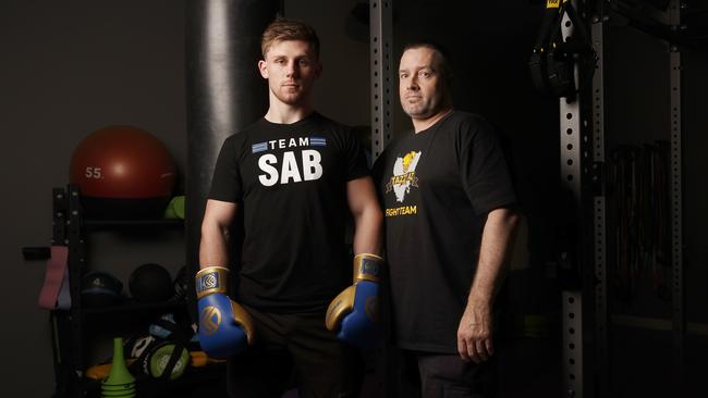 Sab Wells with coach Adrian Lovell. Lovell believes Wells has all the makings to follow in the footsteps of Tasmanian Commonwealth Games boxer Daniel Geale. Picture: Nikki Davis-Jones