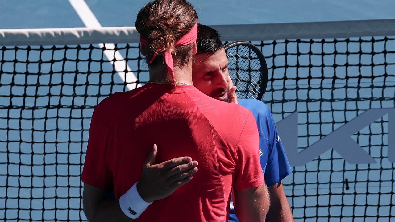 The pair were seen embracing before the chair umpire announced to the crowd that Djokovic pulled out due to injury. Picture: David Gray / AFP