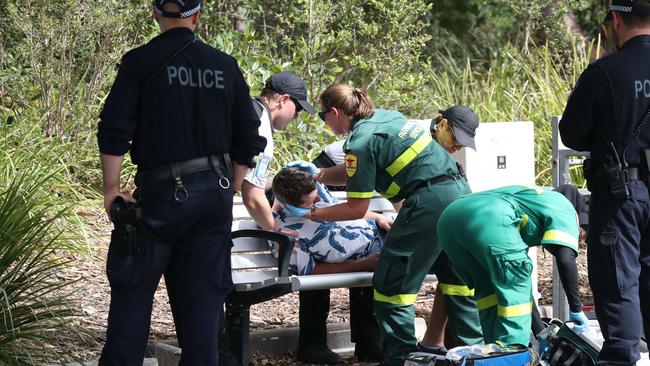 Police watch on as paramedics treat a suspected drug overdose at Festival X. Picture: David Swift