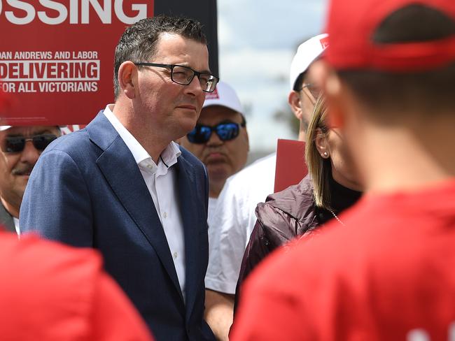 Victorian Premier Daniel Andrews (second left) and  Marlene Kairouz (right) are seen with Labor party supporters wearing red shirts at Deer Park train station in Melbourne, Thursday, November 22, 2018. Victorians go to the polls on Saturday. (AAP Image/Julian Smith) NO ARCHIVING