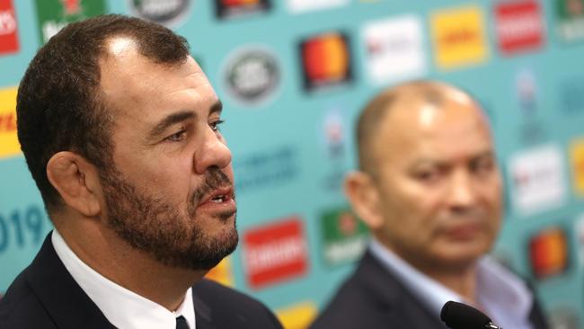 Australia coach Michael Cheika speaks to the media beside England coach Eddie Jones.