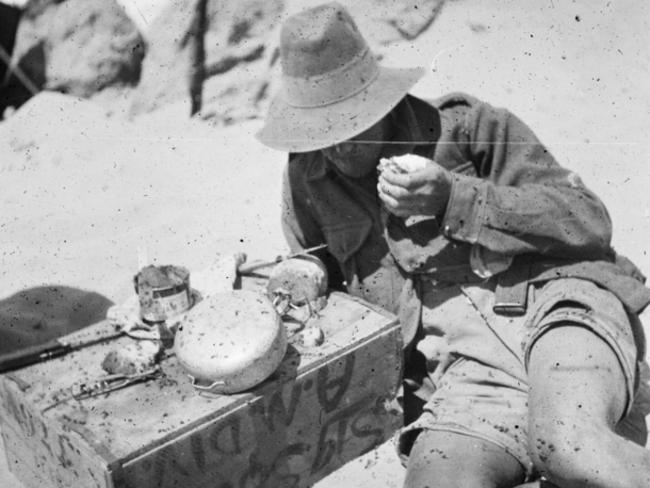 A soldier finds a brief moment between firefights to fix a basic ration meal.