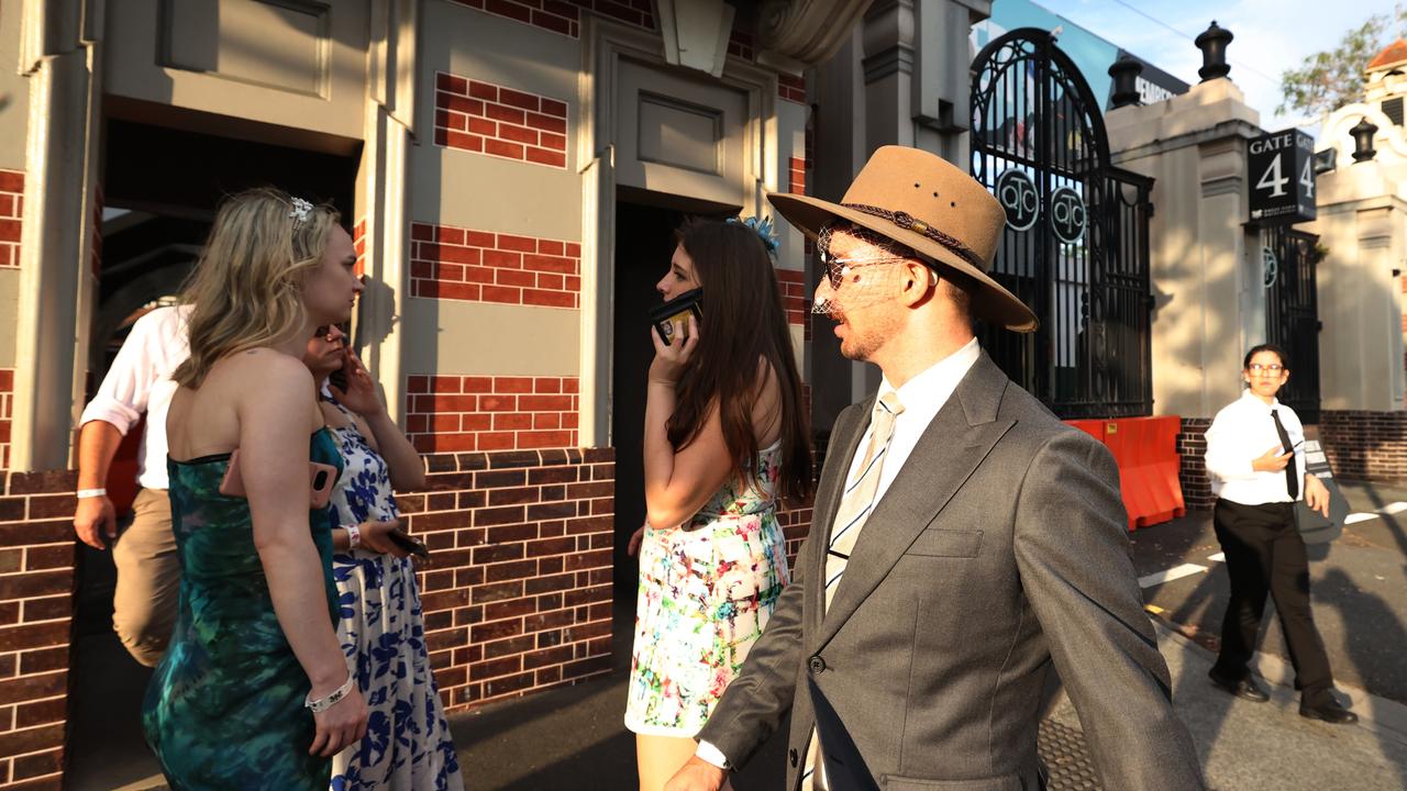 Punters leave Eagle Farm racecourse on Melbourne Cup Day.