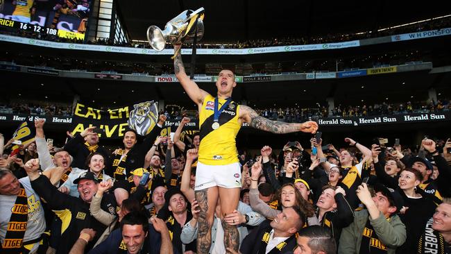 Dustin Martin celebrates with the Premiership Cupand Tiger Army in 2017. Picture. Phil Hillyard