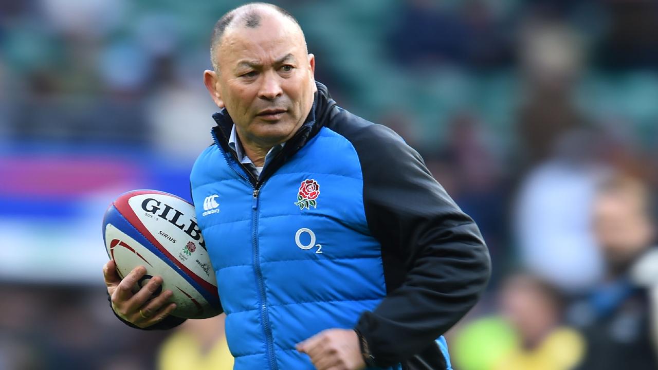 England's coach Eddie Jones checks out the pitch conditions.