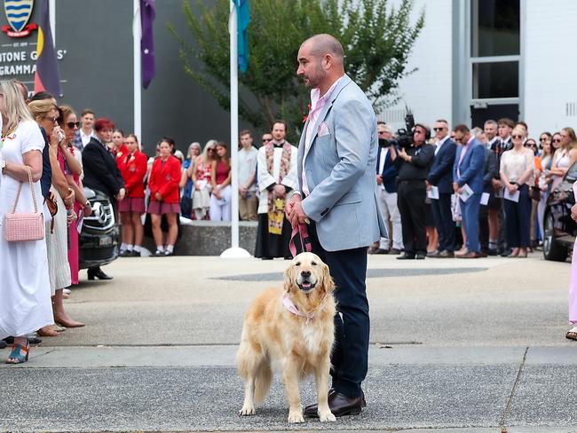 Bianca Jones’ father Mark Jones holds onto Zara the family dog after the service. Picture: NewsWire/Ian Currie