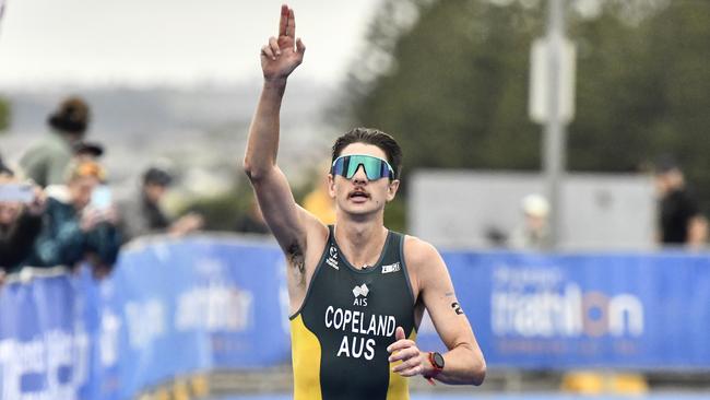 DEVONPORT, AUSTRALIA - MARCH 15: Brandon Copeland of Australia approaches the finish line in the Men's Under 23 and Elite event at the 2025 Devonport Triathlon on March 15, 2025 in Devonport, Australia. (Photo by Simon Sturzaker/Getty Images)