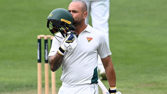 HOBART, AUSTRALIA - MARCH 17: Jake Weatherald of Tasmania kisses his helmet after scoring a century during the Sheffield Shield match between Tasmania and New South Wales at Blundstone Arena, on March 17, 2025, in Hobart, Australia. (Photo by Steve Bell/Getty Images)