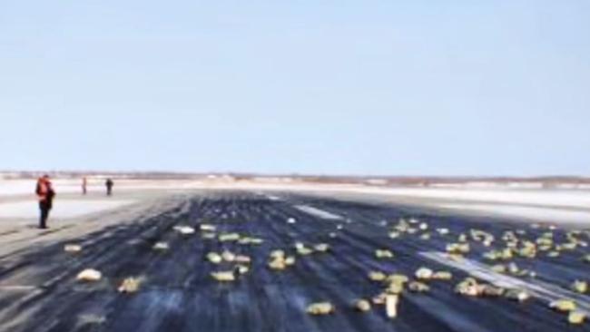 This screen capture shows some of the gold ingots scattered at the -lift-off point of the cargo aircraft at Yakutsk airport, eastern Siberia. Picture: TASS