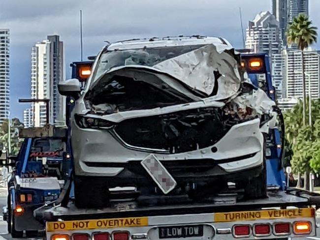 A tow truck removes a vehicle which crashed on the Gold Coast Highway in Southport after the driver suffered a medical incident. Picture: Keith Woods.
