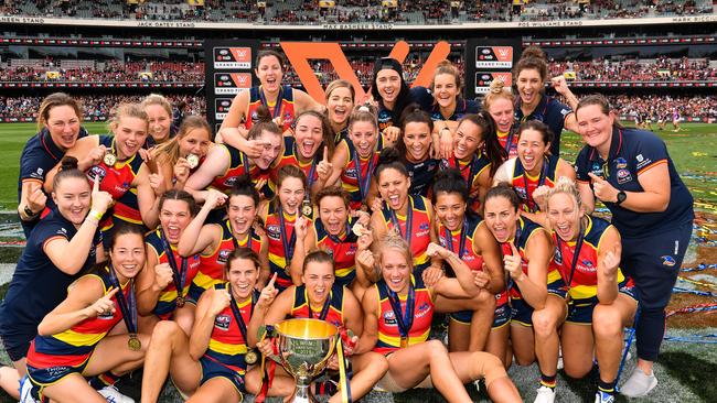 Adelaide Crows players celebrate with the AFLW Premiership Cup at Adelaide Oval in March. Picture: Daniel Kalisz/Getty Images