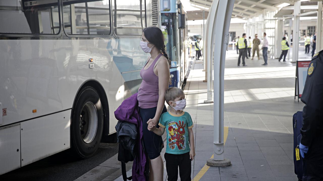 First lot of international arrivals landing and being put on buses heading to hotels to be quarantined at Sydney international airport this morning, March 29 2020.