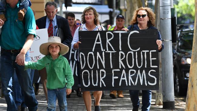 Farmers and rural residents from the Darling Downs region march towards the Commonwealth offices in Brisbane, Tuesday, February 18, 2020. The group was protesting against the planned construction of the inland rail route from Melbourne to Brisbane on the Condamine floodplain. (AAP Image/Dan Peled) NO ARCHIVING