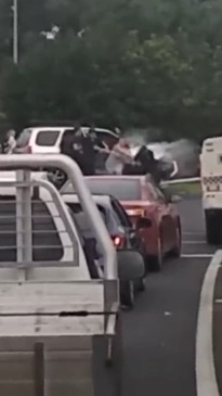 Wild moment woman is ripped from car with kids in the back