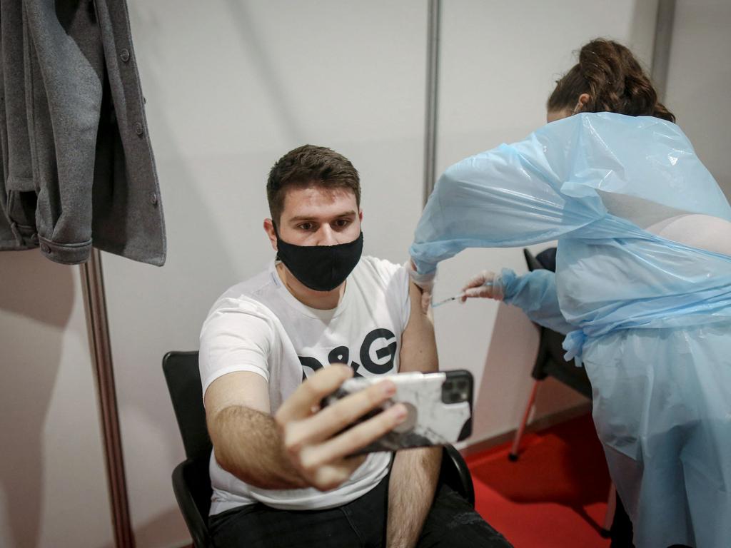 A Bosnian citizen takes a selfie picture while receiving a dose of the AstraZeneca COVID-19 vaccine at one of Belgrade's vaccination centre. Picture: AFP