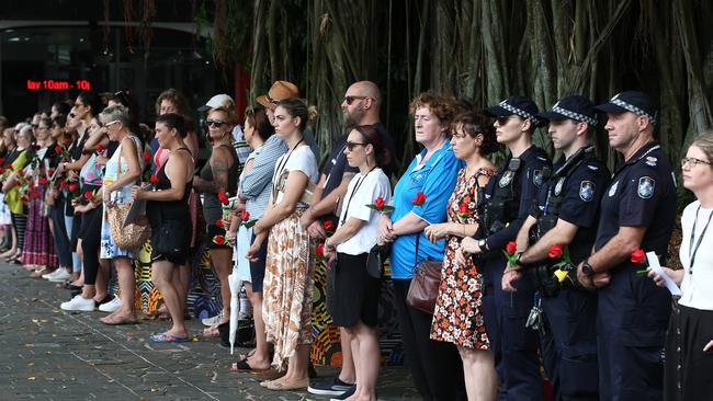 Women and men stood in silence side by side on Shields Street for the Red Rose Rally, which raised awareness and aimed to eliminate domestic and family violence in our society. PICTURE: BRENDAN RADKE