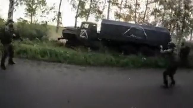 Members of the Ukrainian hit squad close in after opening fire on a Russian truck.