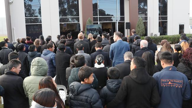 The crowd spills outside at Pasawm Lyhym’s funeral.