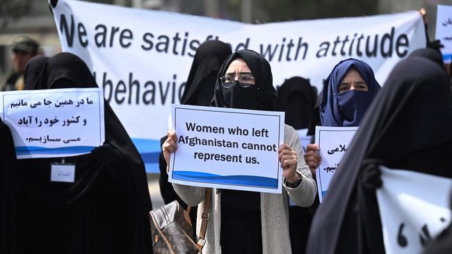 Women hold banners and placards at a pro-Taliban rally in Kabul on Saturday. Picture: AFP