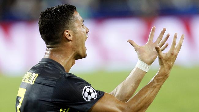 Baffled … Cristiano Ronaldo pleads with the referee after being sent off. Photo: AP