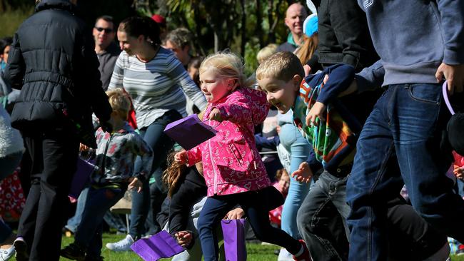 Eva Warren, 4, of Oakdowns, races for the best spot in the RHH Foundation Easter Egg hunt at the Botanical Gardens.