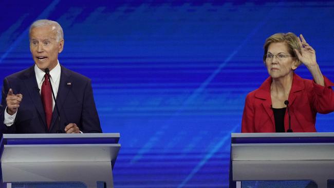 Joe Biden answers a question as Elizabeth Warren reacts. Picture: AP.