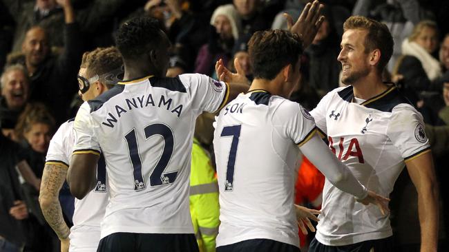 Tottenham Hotspur's English striker Harry Kane (R) celebrates with teammates after scoring.