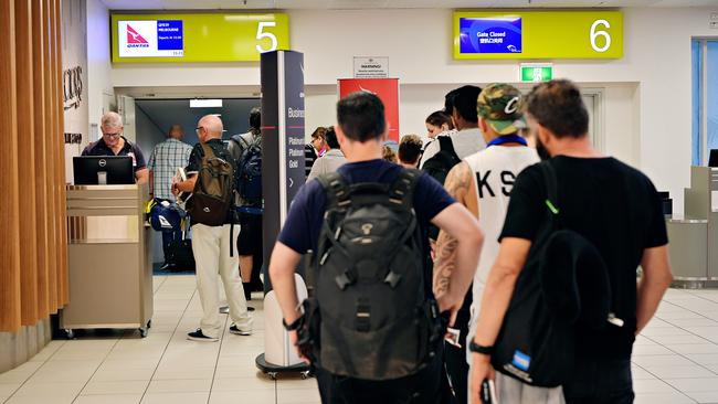 Passengers line up to board a Qantas flight at Darwin International Airport. Picture: Michael Franchi