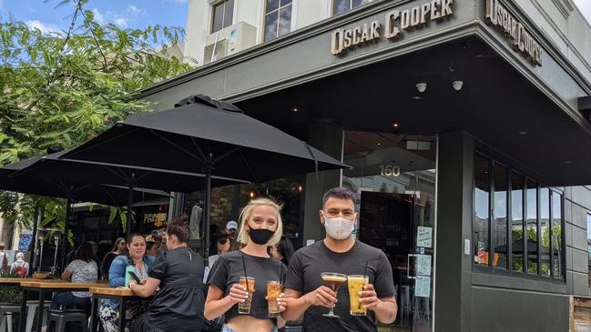 Oscar Cooper staff members Molly Mattison and Daniel Vergara in the on-street dining area on Prahran’s Greville St. Picture: Kiel Egging.