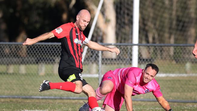 Gold Coast Premier League star Matt Hilton takes on Nerang goalkeeper Samuel Fowler.